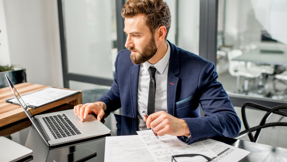 cpa-reviewing-financial-paperwork Small business CPA selection tips from Hacker, Johnson & Smith