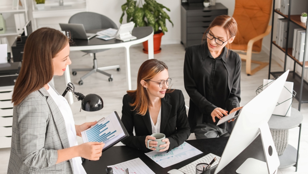 cpa-team-meeting-reviewing-financial-documents Insights on hiring a local CPA versus using online accounting services from Hacker, Johnson & Smith PA